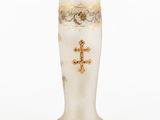 a white vase with a gold cross on it