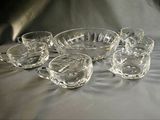 a group of glass bowls and cups sitting on a table