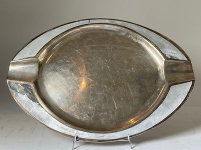 a silver plate that is sitting on a stand