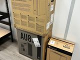 a stack of boxes sitting on the floor next to a shelf