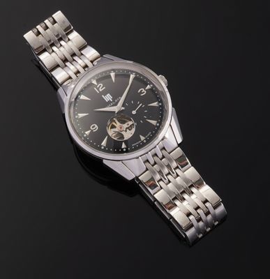 an image of a close up of a wrist watch on a black surface