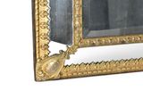 a mirror with a gold frame and a mirror with a bird on it