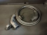 a cable connected to a power cord on a table