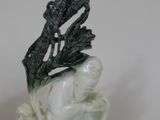 statue of a man with a bird on his head on top of a table