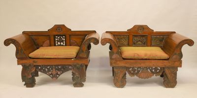 pair of antique carved wood chairs with upholstered cushions