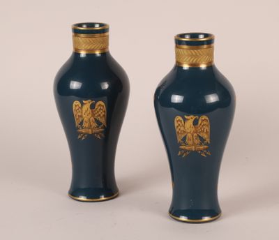 une paire de vases bleus ornés de motifs dorés sur fond blanc