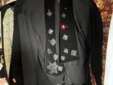 a suit and tie hanging on a hanger in a room