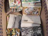 a cardboard box filled with books and pictures