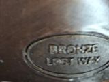 a close up of a metal object with a name on it