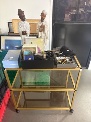 two statues that are sitting on a table in a room