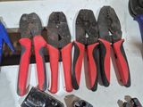 several pliers and pliers are lined up on a table