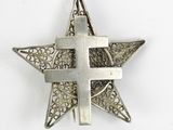a close up of a metal star with a cross on it