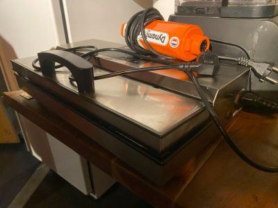 an orange blow dryer sitting on top of a table