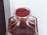 a glass bottle with a red wax seal on top of it