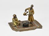 figurine en bronze représentant un homme et une femme sur un tapis