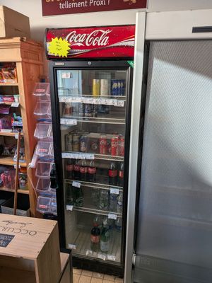 a refrigerator in a store with a sign on the door