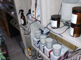 a shelf with candles, candles, and other items on it