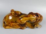 a figurine of a dog laying down on its back