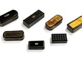 a lot of small black and yellow objects on a white surface