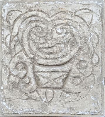 an image of a stone carving of a man with a hat on his head