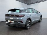 the rear view of a grey volkswagen suv parked in a garage