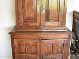 a wooden cabinet with a mirror on top of it