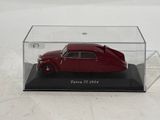 a red car in a clear case on a white surface