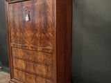 an old wooden cabinet with a key on top of it