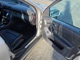 a car with its door open sitting in a parking lot