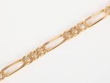 a close up of a gold chain on a white surface