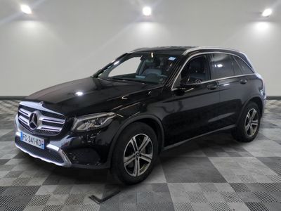 the mercedes gle suv is parked in a large room