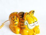 a yellow tiger figurine on a white background