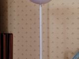 a white floor lamp that is next to a blue chair