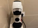 a coffee maker sitting on top of a counter in a bathroom