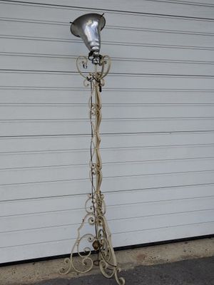 a lamp that is on a stand in front of a garage