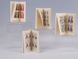 four small books are stacked on top of each other on a table