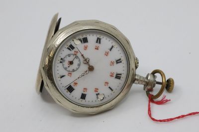 a silver pocket watch with roman numerals on it
