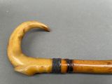 a wooden stick with a curved handle on a table
