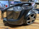 a black and silver vacuum on a wooden table