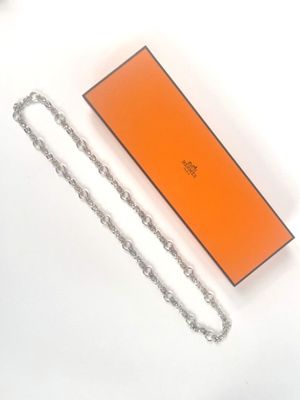 an orange box with a chain attached to it sitting on a white surface