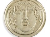 an image of a gold coin with a woman ' s face on it
