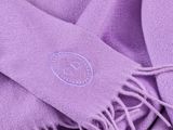 purple scarf with a logo on it laying on top of a table
