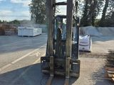 a forklift that is parked on the side of the road