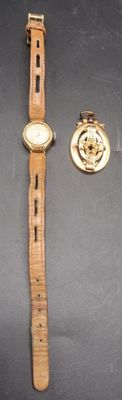 a watch and a lapel sitting on a table