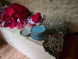 many plates and cups on a table in a room