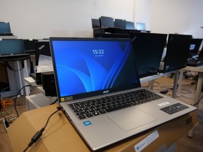 a laptop computer sitting on top of a wooden table