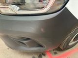 a close up of a car ' s front bumper and headlight