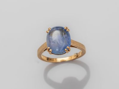 a gold ring with a blue stone in the center