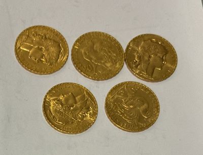four gold coins sitting on top of a piece of paper