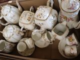 a box full of teapots and cups and saucers